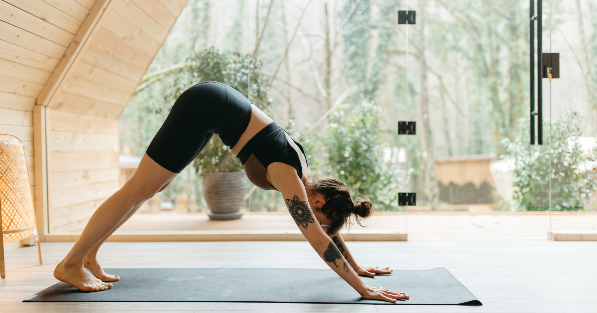 Active Rest Day/Active Recovery- woman performing the 'down dog' yoga pose 
