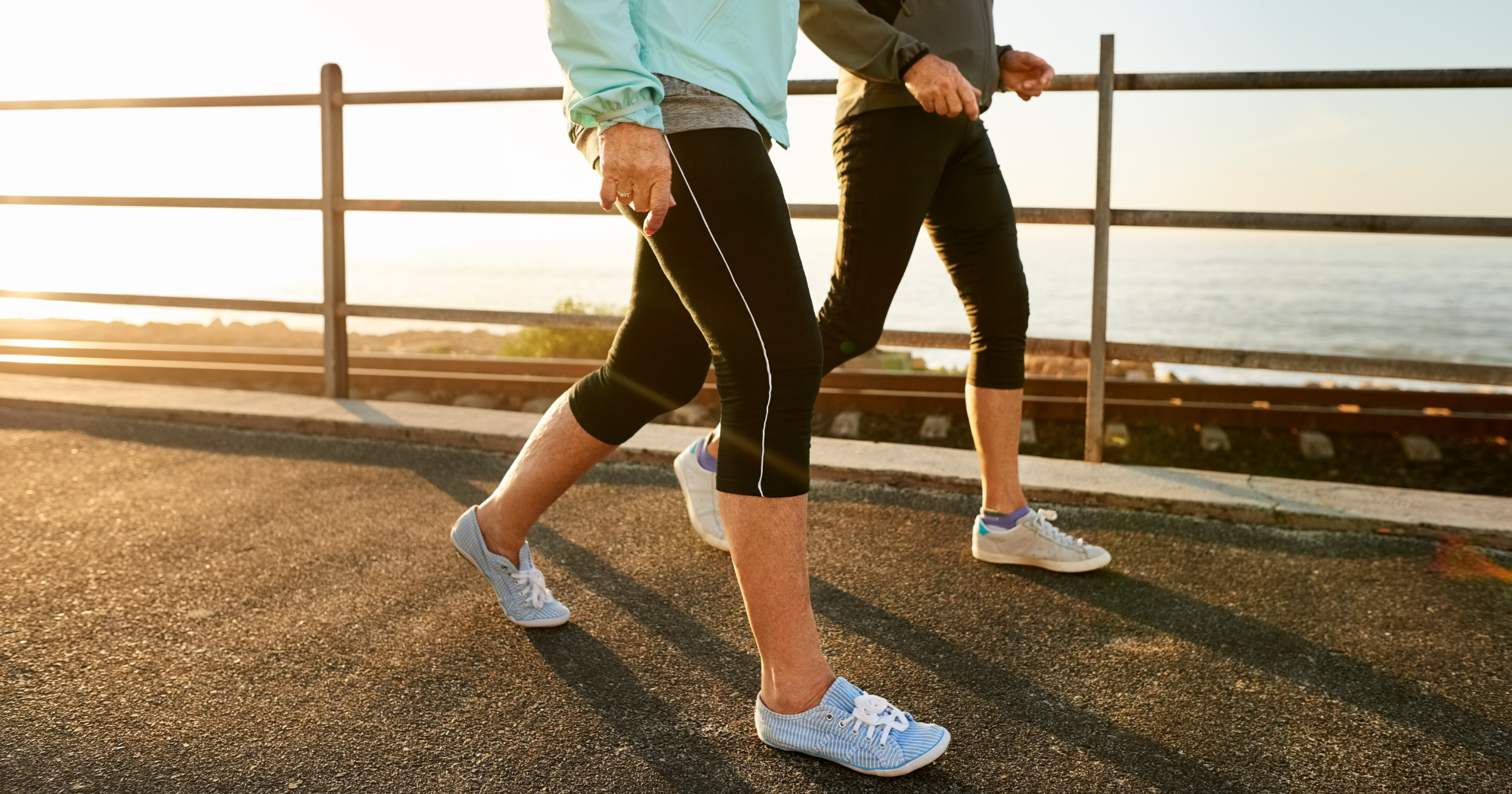 Can Walking Lower Blood Pressure? two people walking on a sunny day by the sea