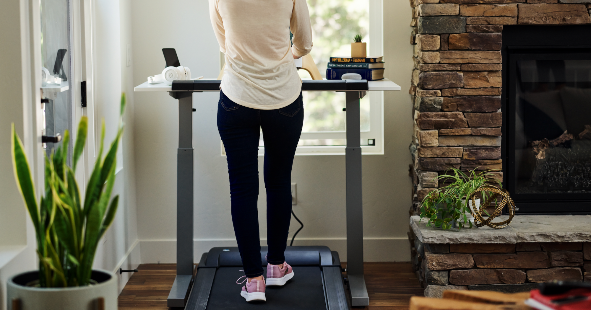 A woman on a walking pad in her home.