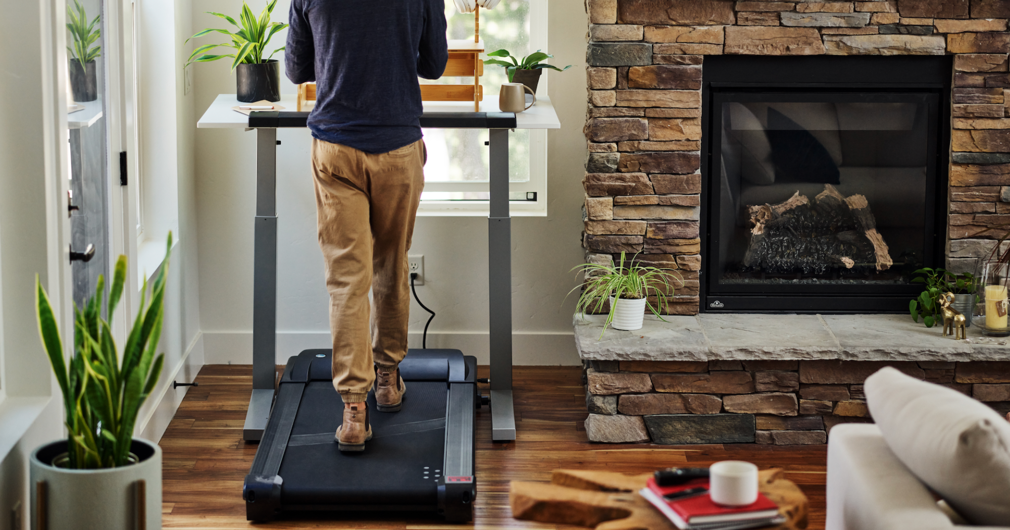 A man engaging in zone 2 cardio by using a walking pad